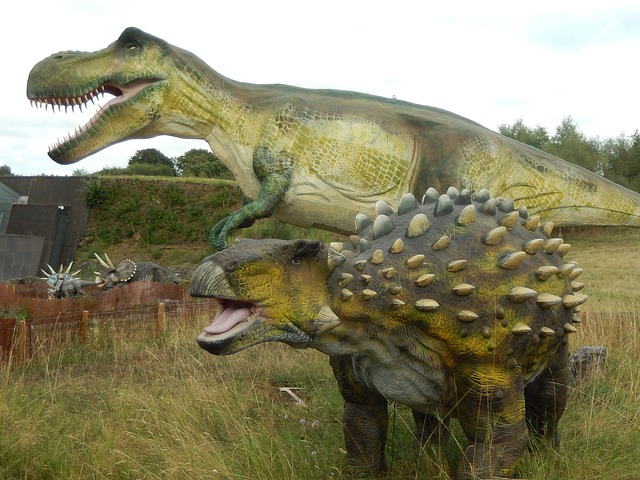 dinosaur statues in grass