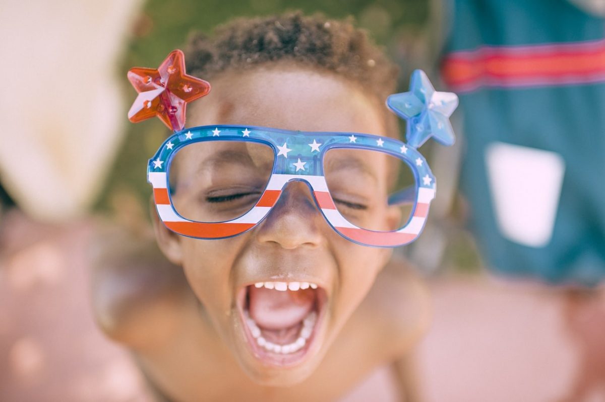 young boy with american flag glasses