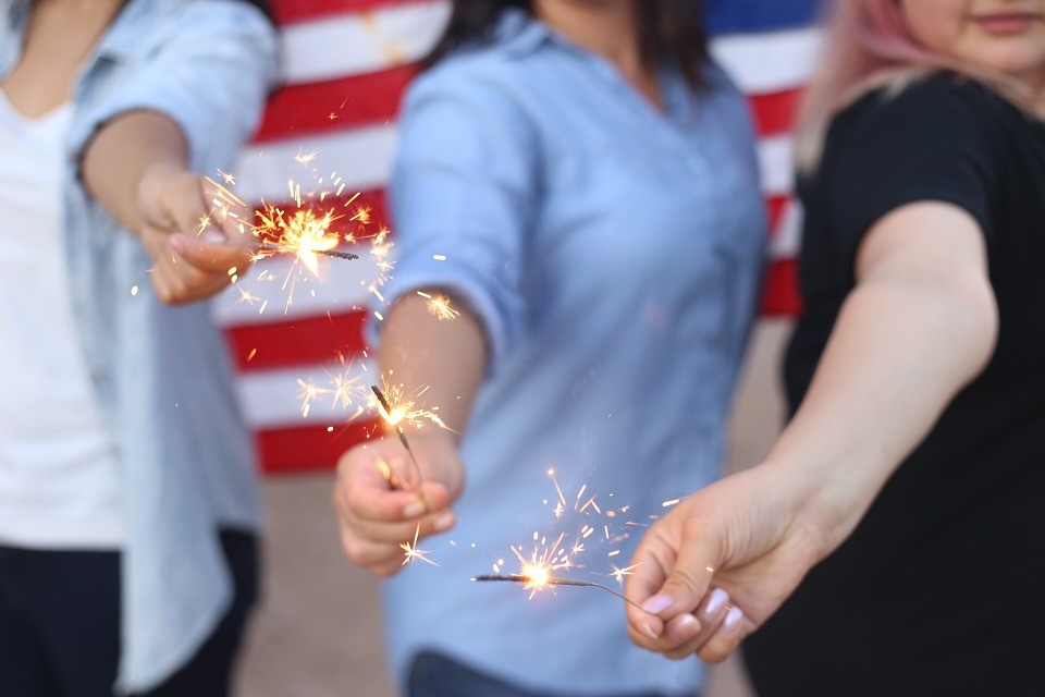 women holding sparklers