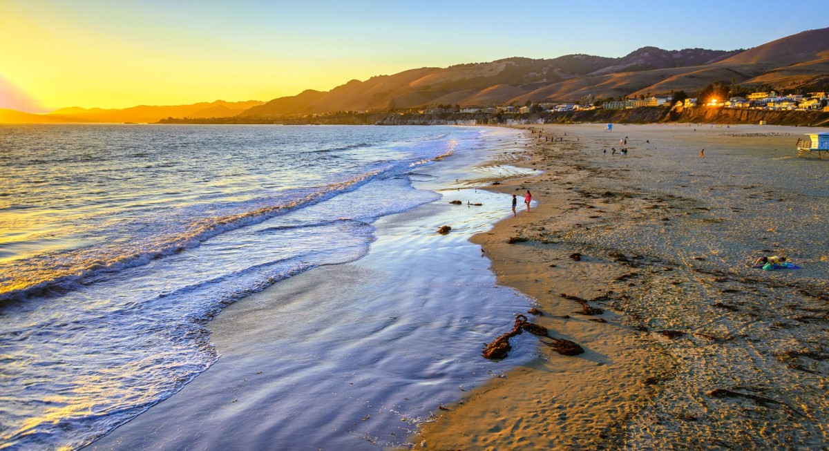 Pismo Beach California at sunset with water rippling across the shoreline. 